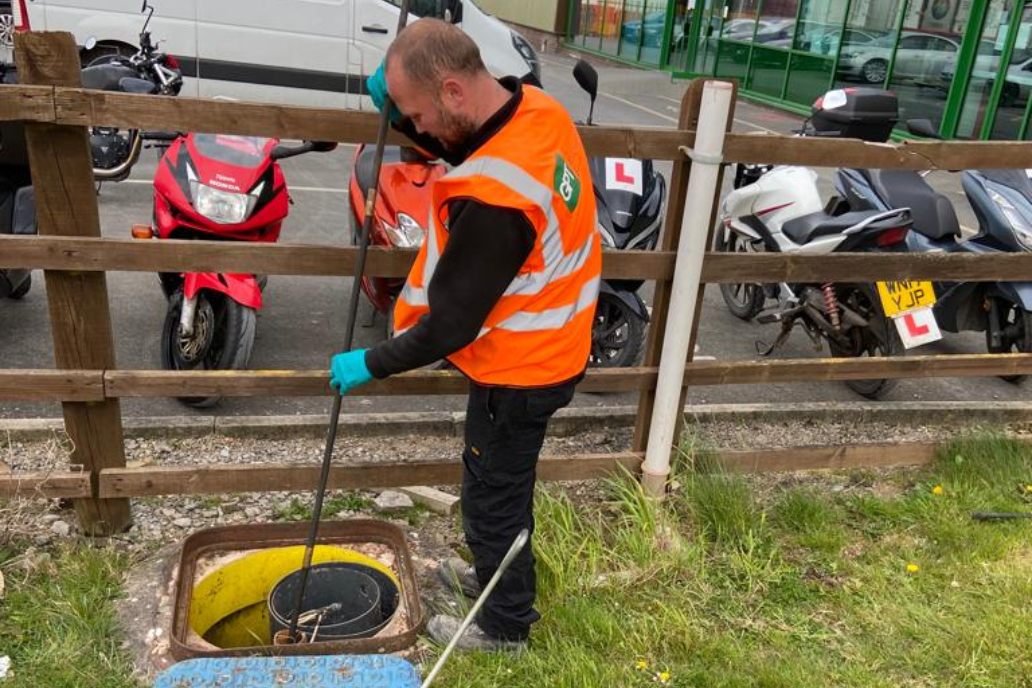 field engineer tanking sample from interceptor chamber during an audit