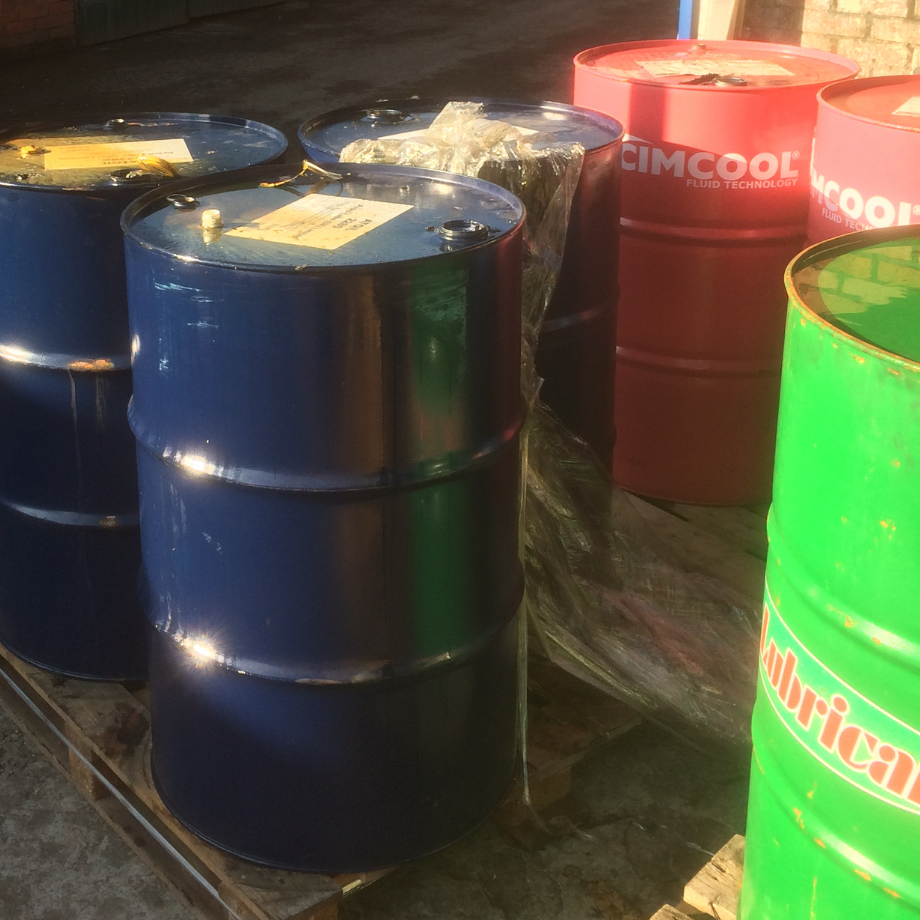 blue green and red hazardous waste drums on a pallet